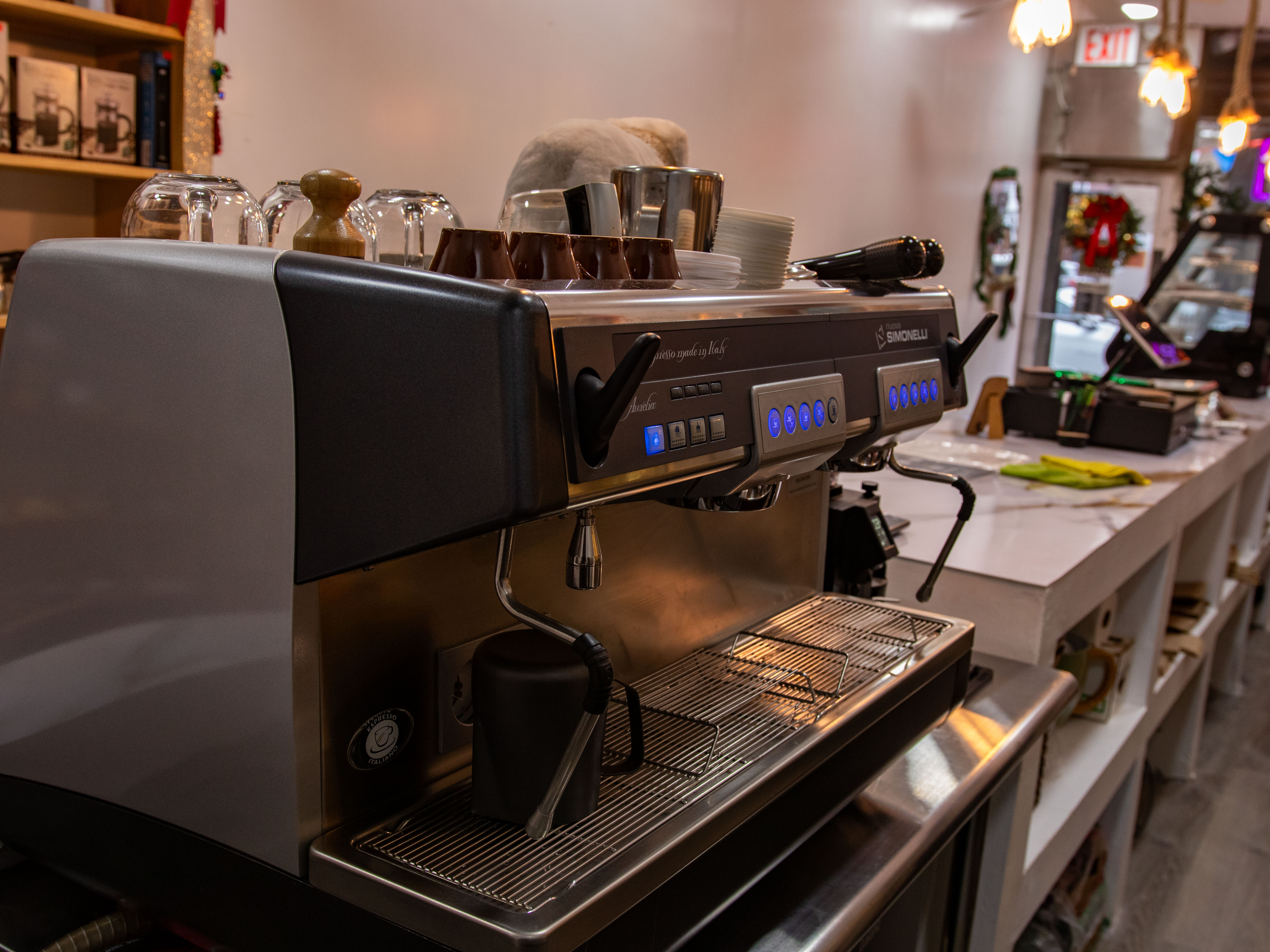 A modern espresso machine in an open kitchen setting, highlighting the equipment and tools available for c...